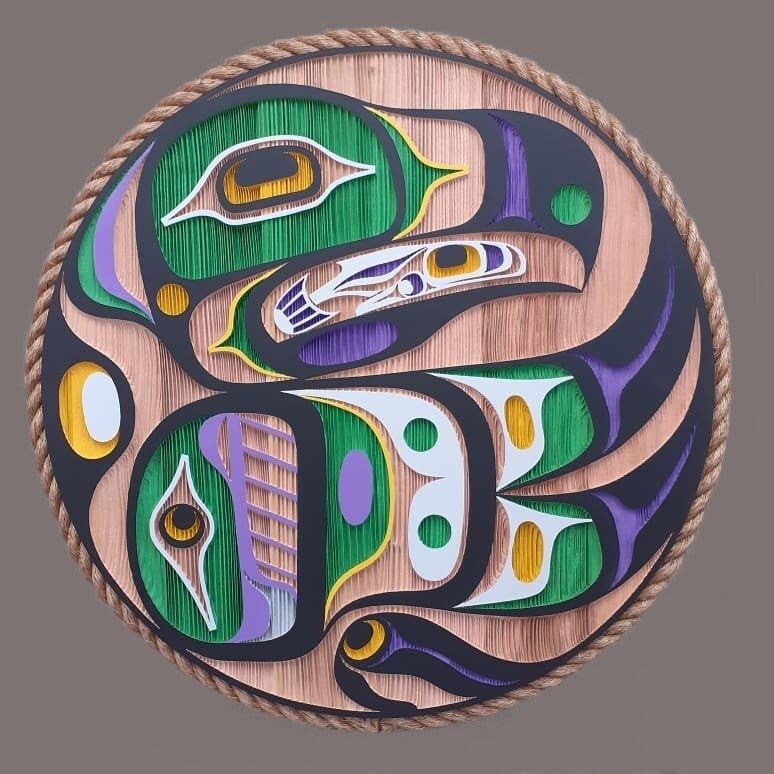 Round eagle and salmon panel painted in green, purple, yellow and black