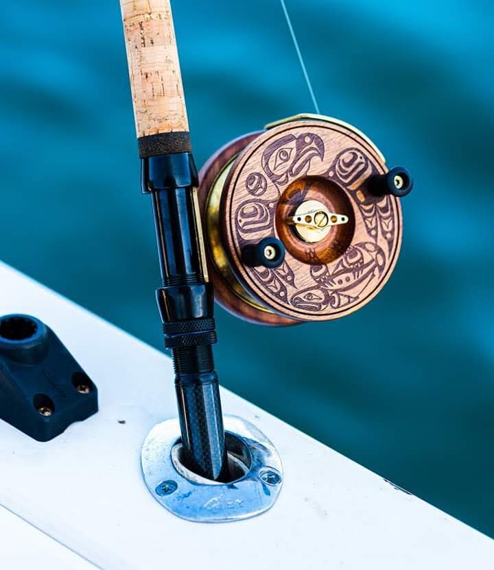 The engraved PEETZ fishing reel with formline design, mounted on a rod at sea