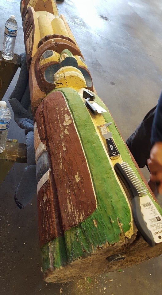 Weathered Henry Hunt pole lying in the workshop with faded, peeling paint