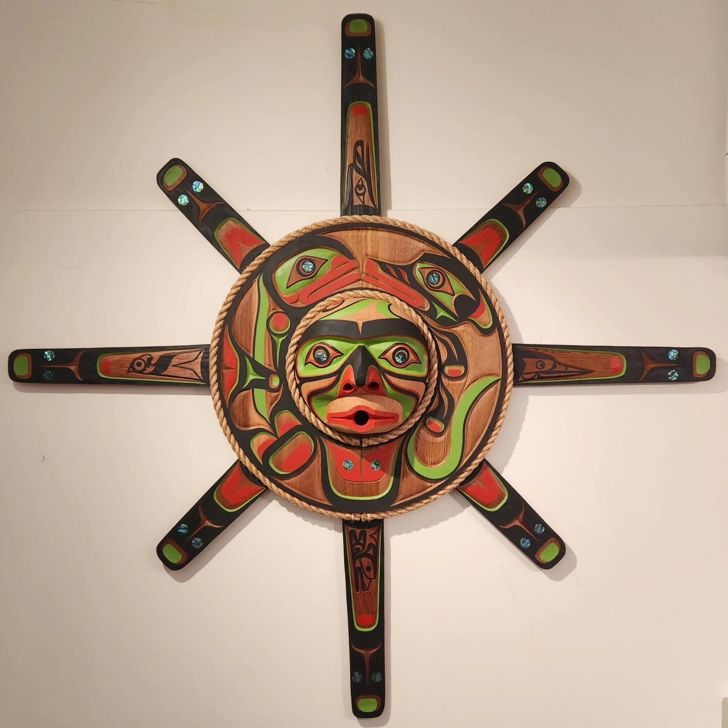 Eight-rayed carved sun mask with abalone inlay