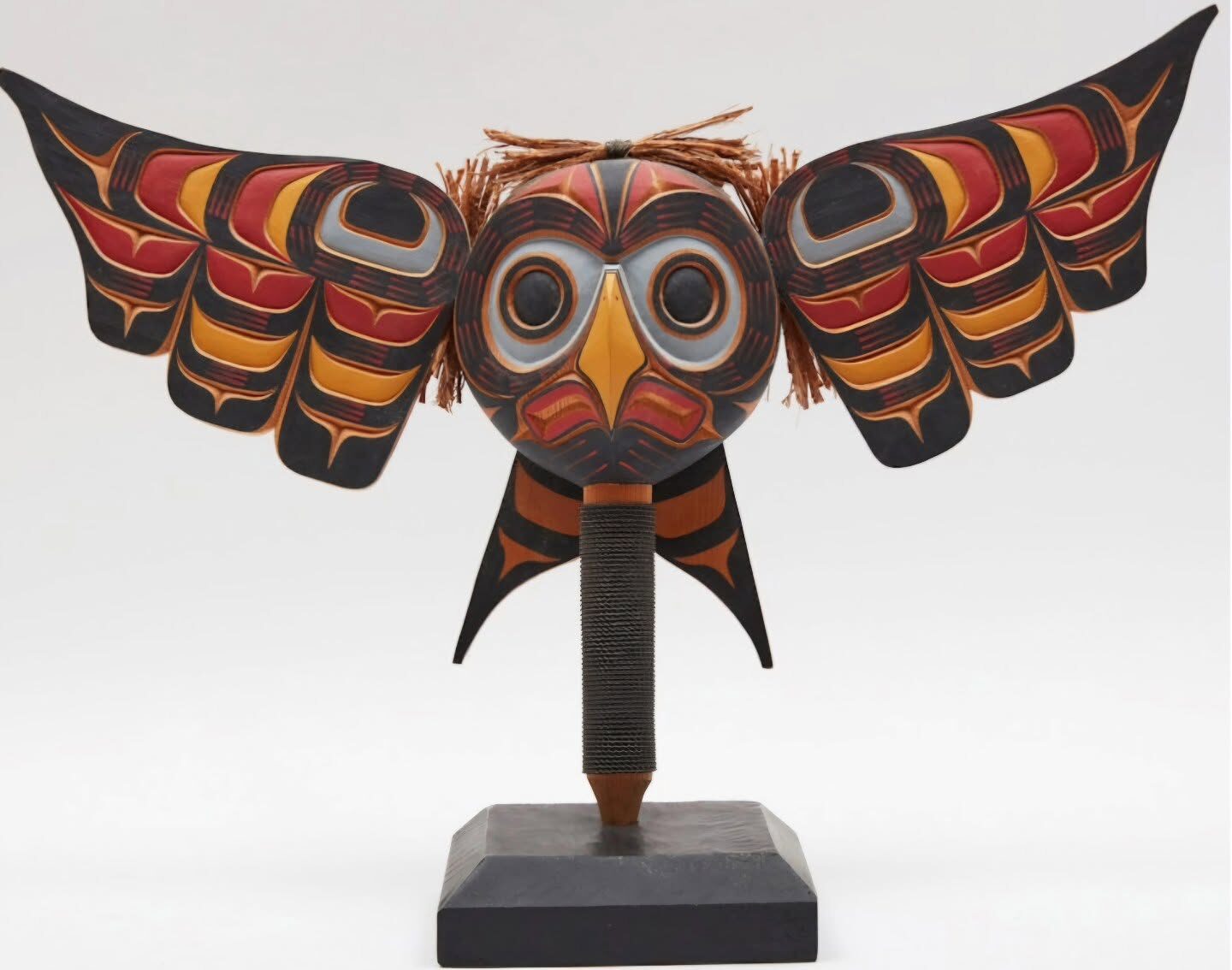 Winged owl sculpture on a display stand